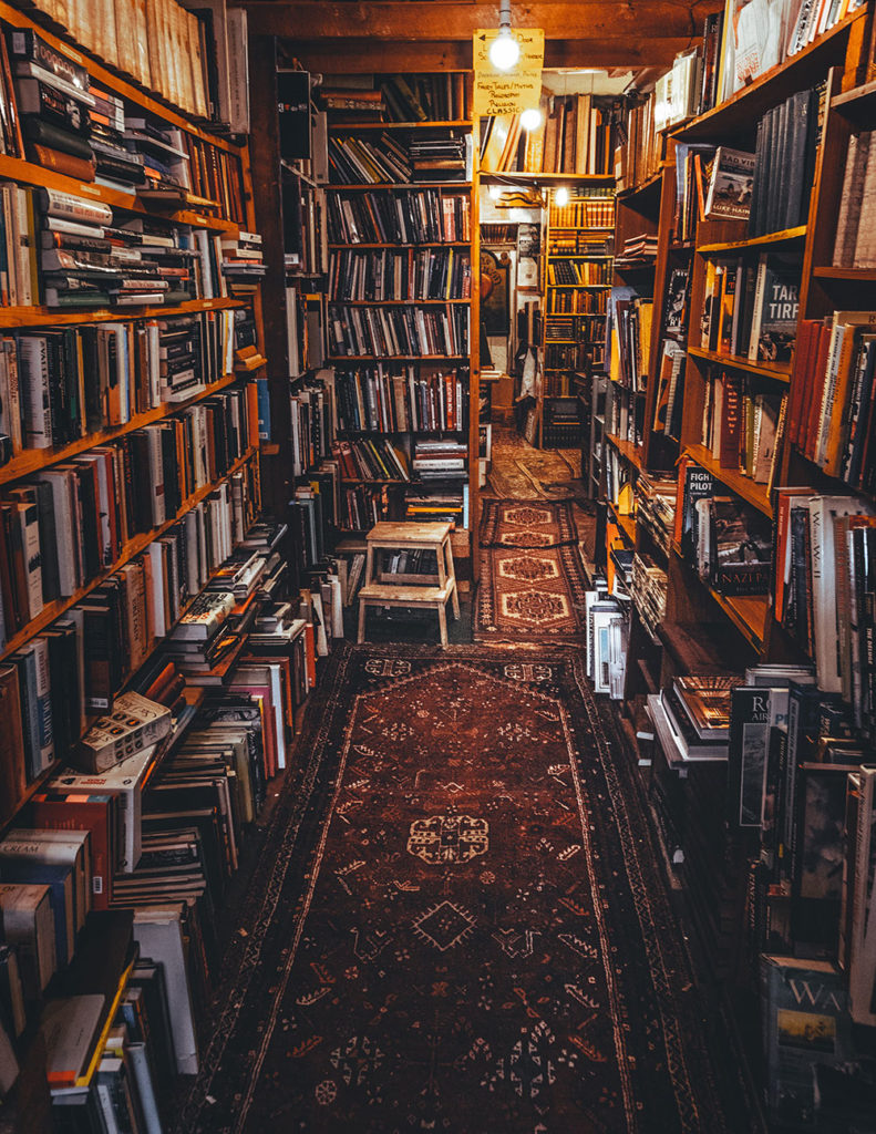 bookstore with piles of books everywhere