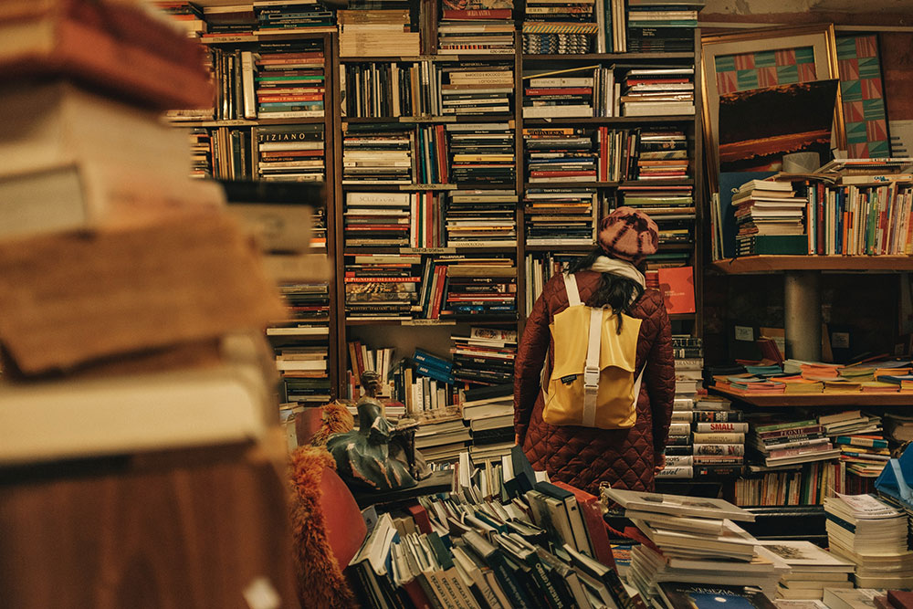 person browsing messy bookstore