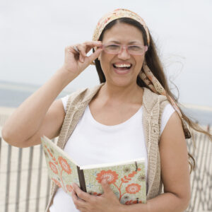 Woman laughing with book