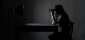 Woman in dark room with binoculars