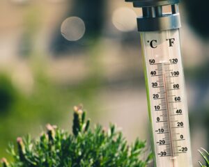 "a outdoor thermometer with a high temperature"