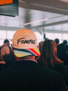 "person with famous written on their cap"