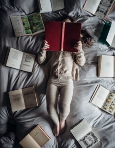 "girl reading in bed"