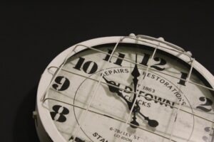 "an analog clock on a black background"