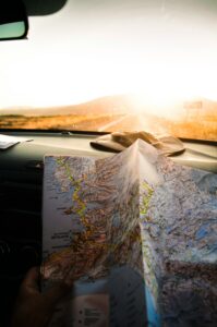 "a paper map on the dash of a car"